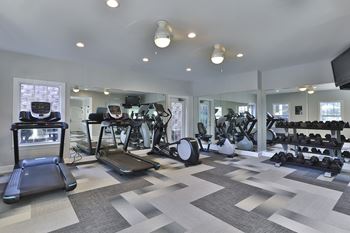 a gym with treadmills and other exercise equipment at Crestmont at Thornblade, Greenville, 29615